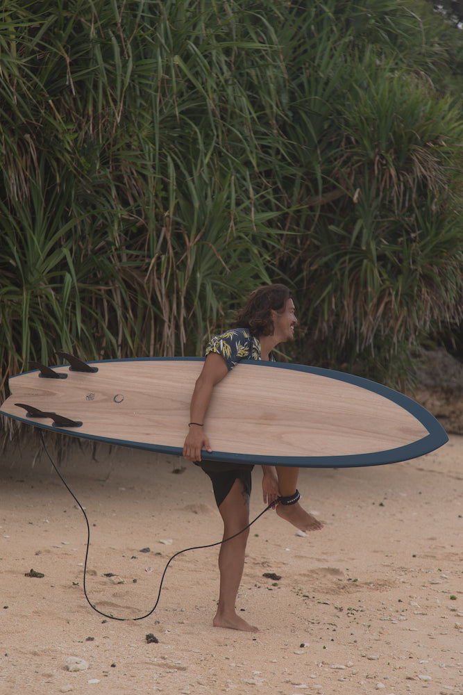 Surfer riding small waves with quad fin setup