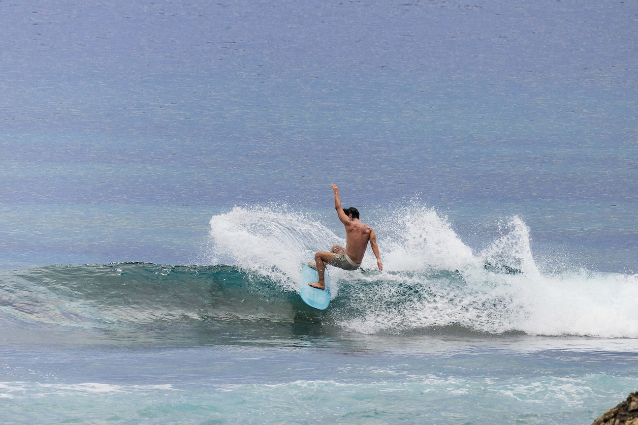 Surfer performing a powerful turn demonstrating fin drive and control